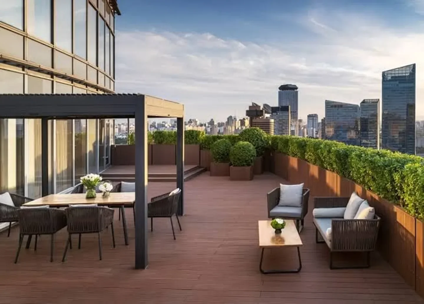 Rooftop terrace at Cai Yi Xuan restaurant in Beijing with city views and elegant seating.