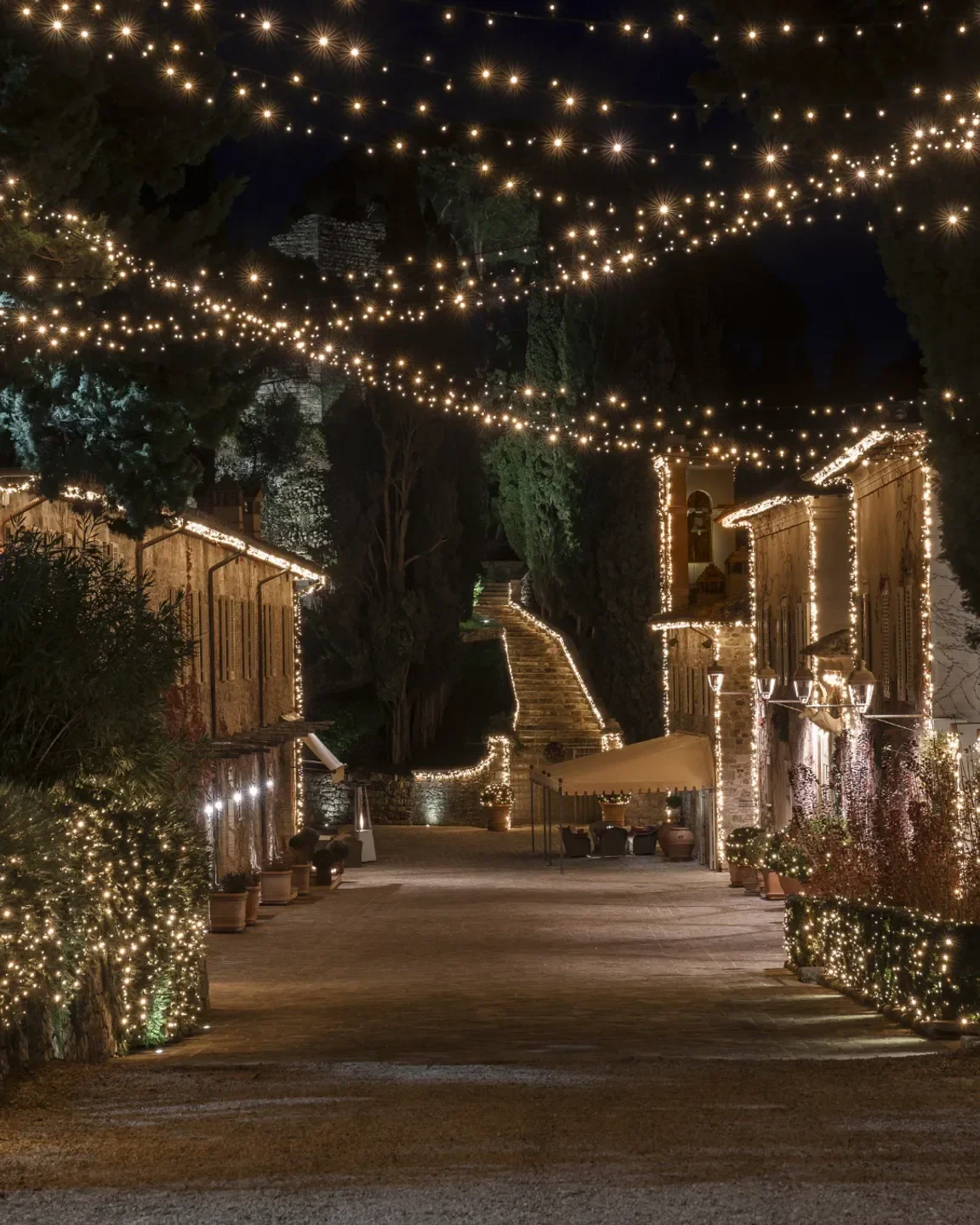 Campo del Drago restaurant in Tuscany, decorated with festive string lights at night.
