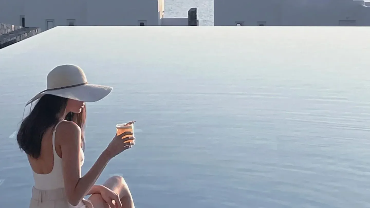 Enjoying a drink by the infinity pool at Canaves in Santorini, Greece.