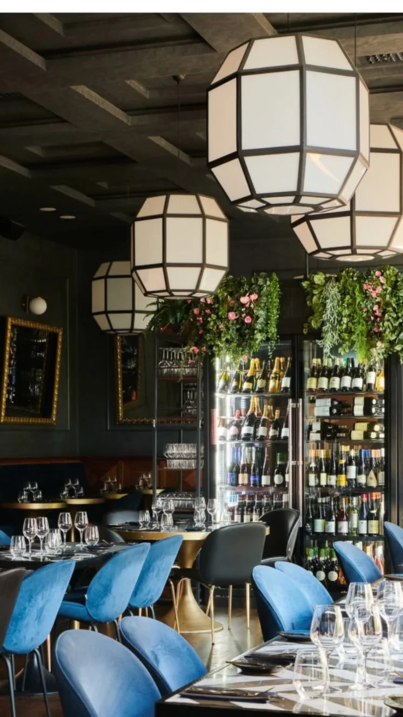 Interior of CAPA restaurant in Copenhagen featuring modern decor, wine display, and elegant dining area.