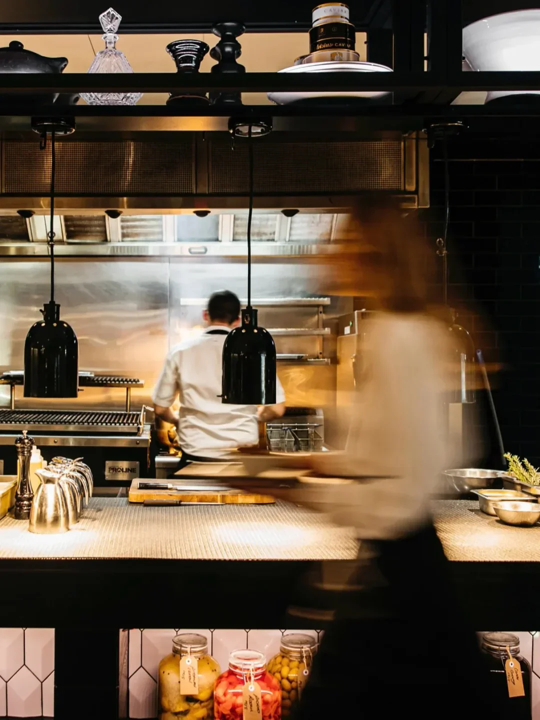 Busy kitchen scene at Capitol Bar & Grill Restaurant in Canberra, chefs at work.