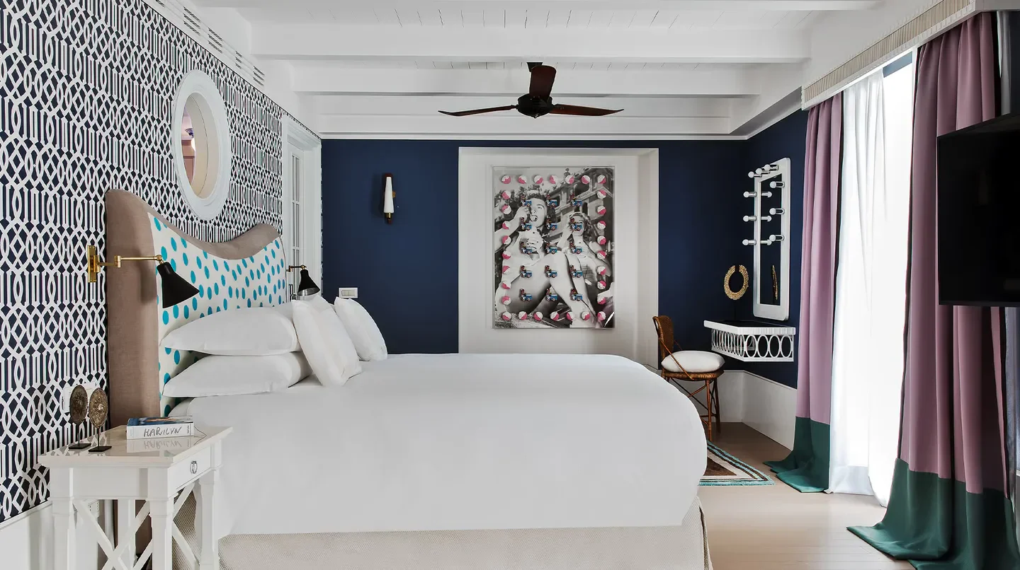 Stylish bedroom at Capri Tiberio Palace hotel in Capri, Italy, featuring vibrant decor.