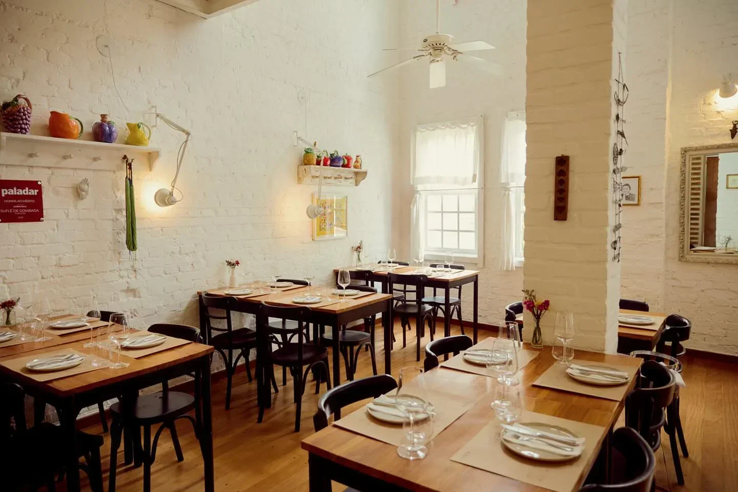 Elegant dining area at Carlota restaurant in Sao Paulo, with tables set for service.