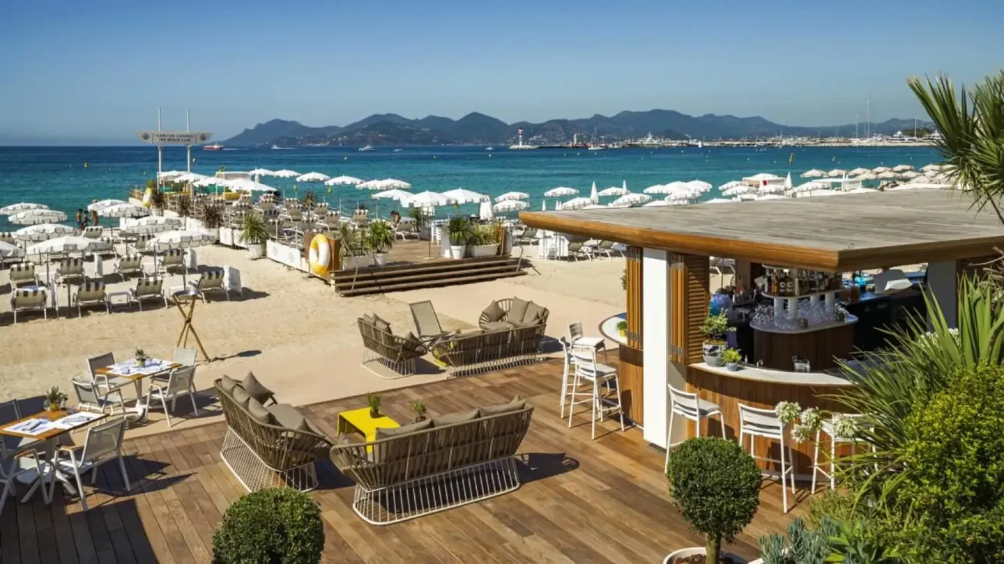 Beachfront bar and lounge at the Carlton Beach Club in Cannes with stunning sea views.