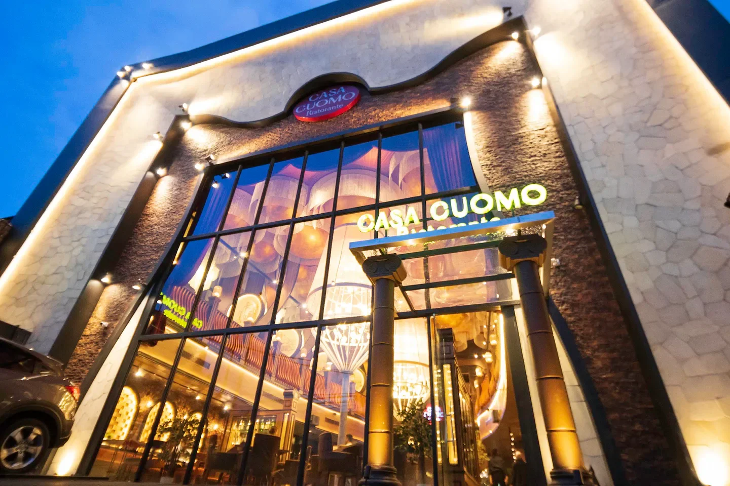 Exterior view of Casa Cuomo by Salvatore Cuomo in Jakarta at dusk, with inviting lights.