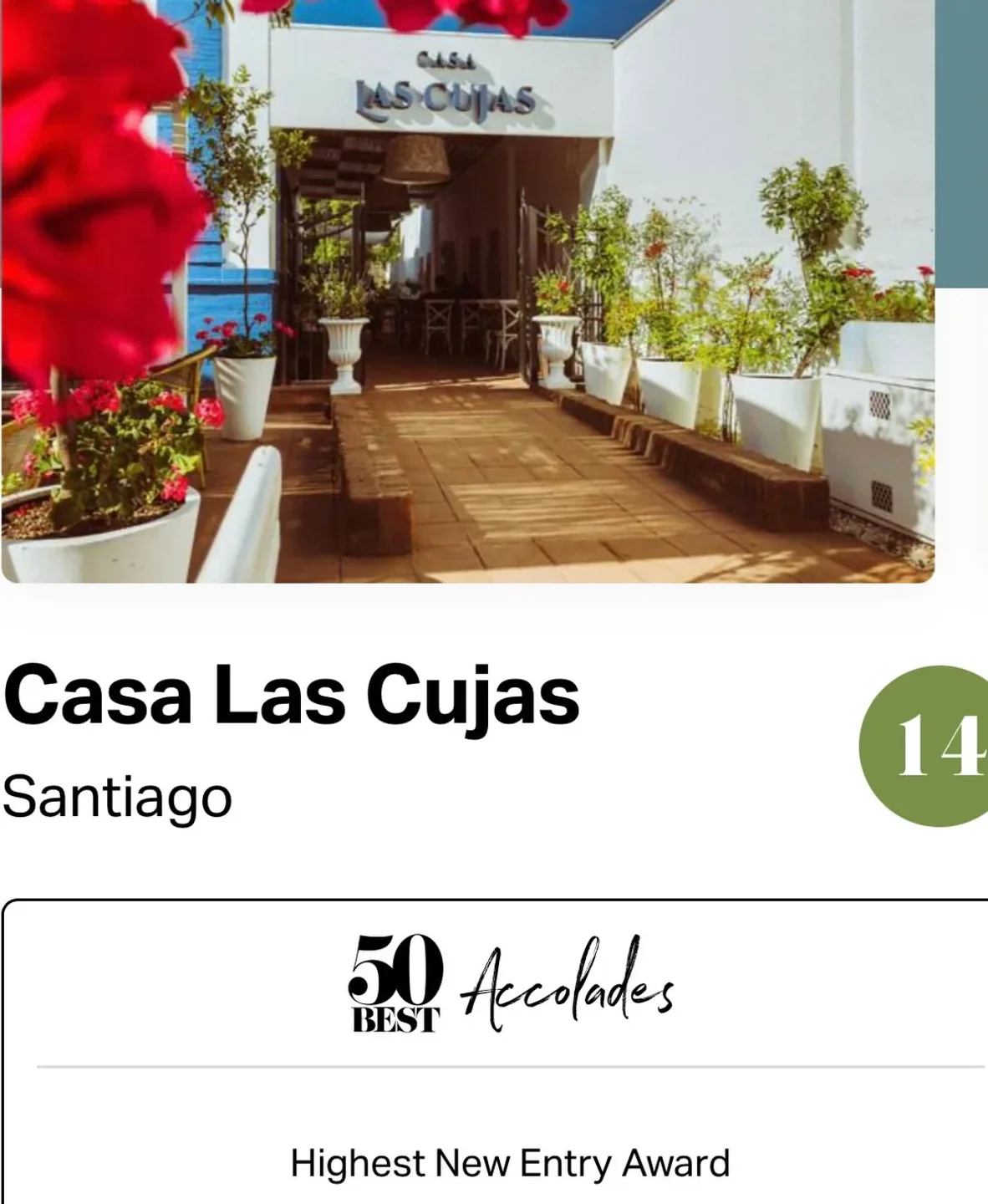 Exterior view of Casa Las Cujas restaurant in Santiago, Chile, showcasing its entrance and patio seating area.