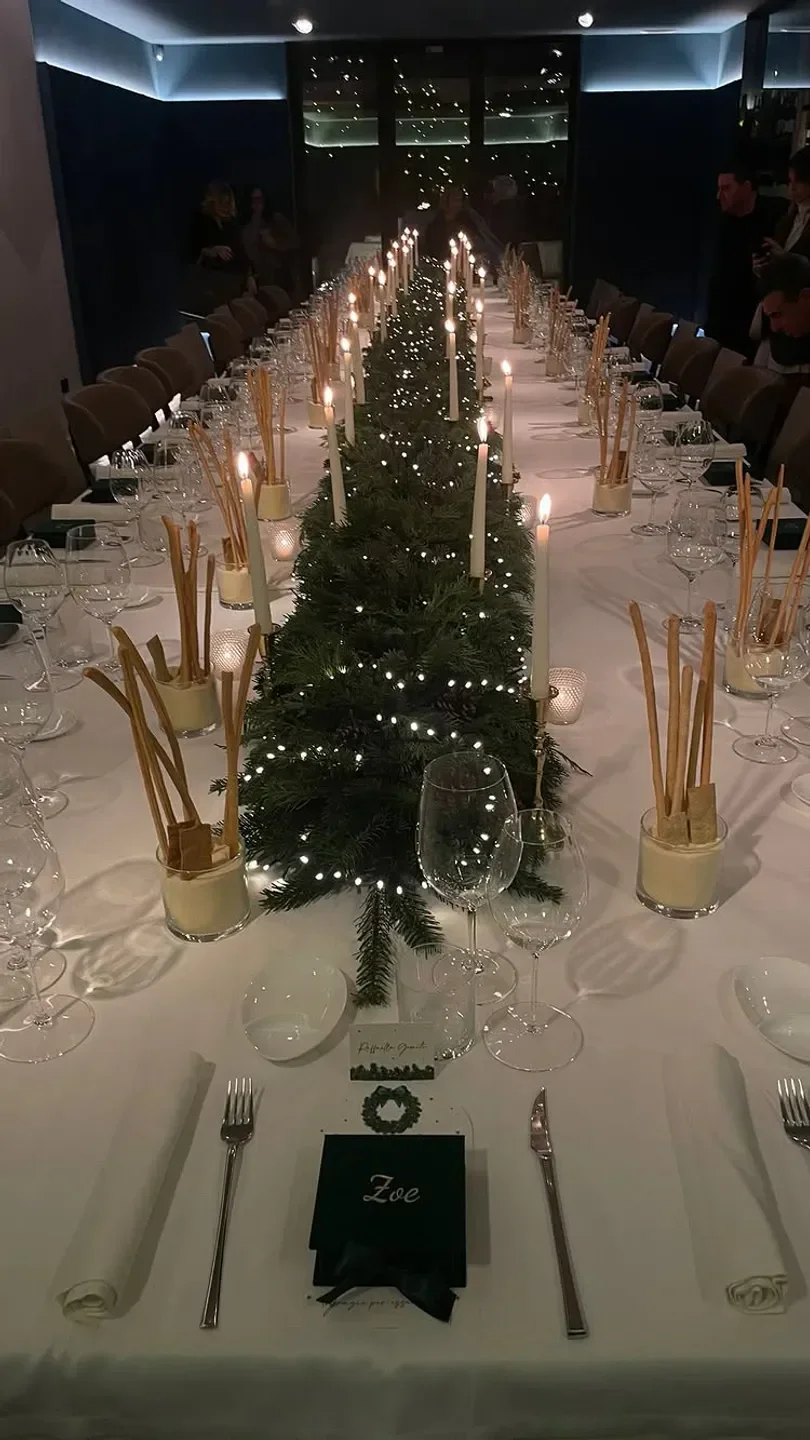 Casa Sgarra restaurant in Puglia: elegant dinner table setting with festive decor and candles.