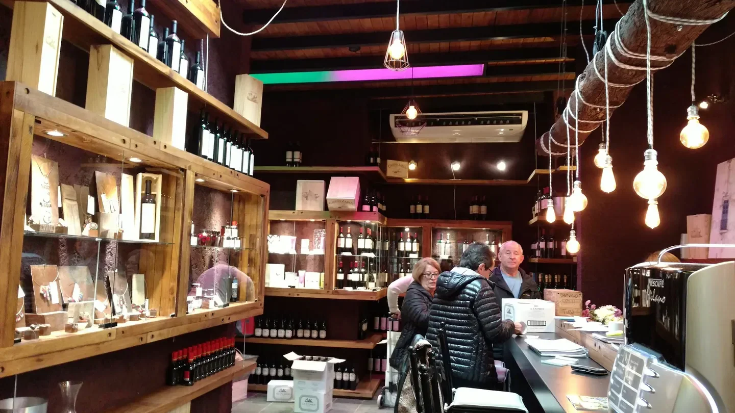 Interior of Casa Vigil restaurant in Mendoza, showcasing wine bottles and welcoming atmosphere.