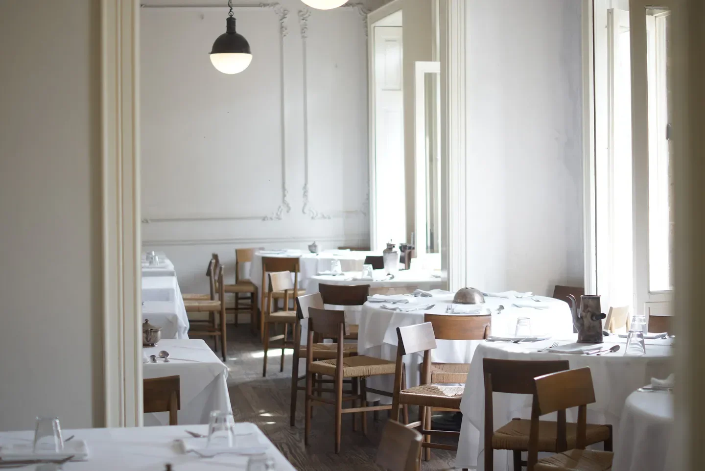 Interior of Casa Virginia restaurant in Mexico City with tables set for service