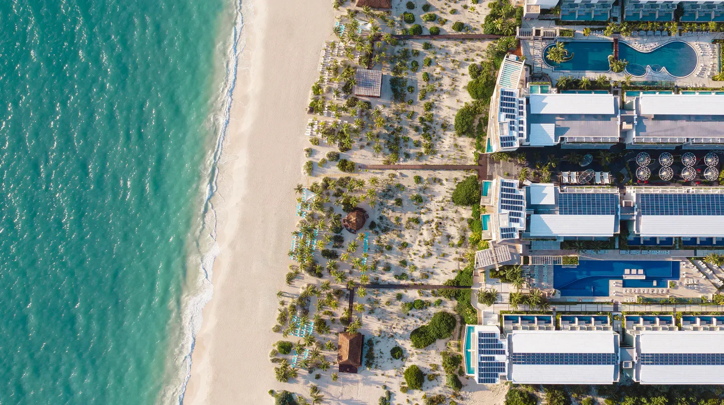 Aerial view of Catalonia Grand Costa Mujeres in Tulum, with beach and pools.
