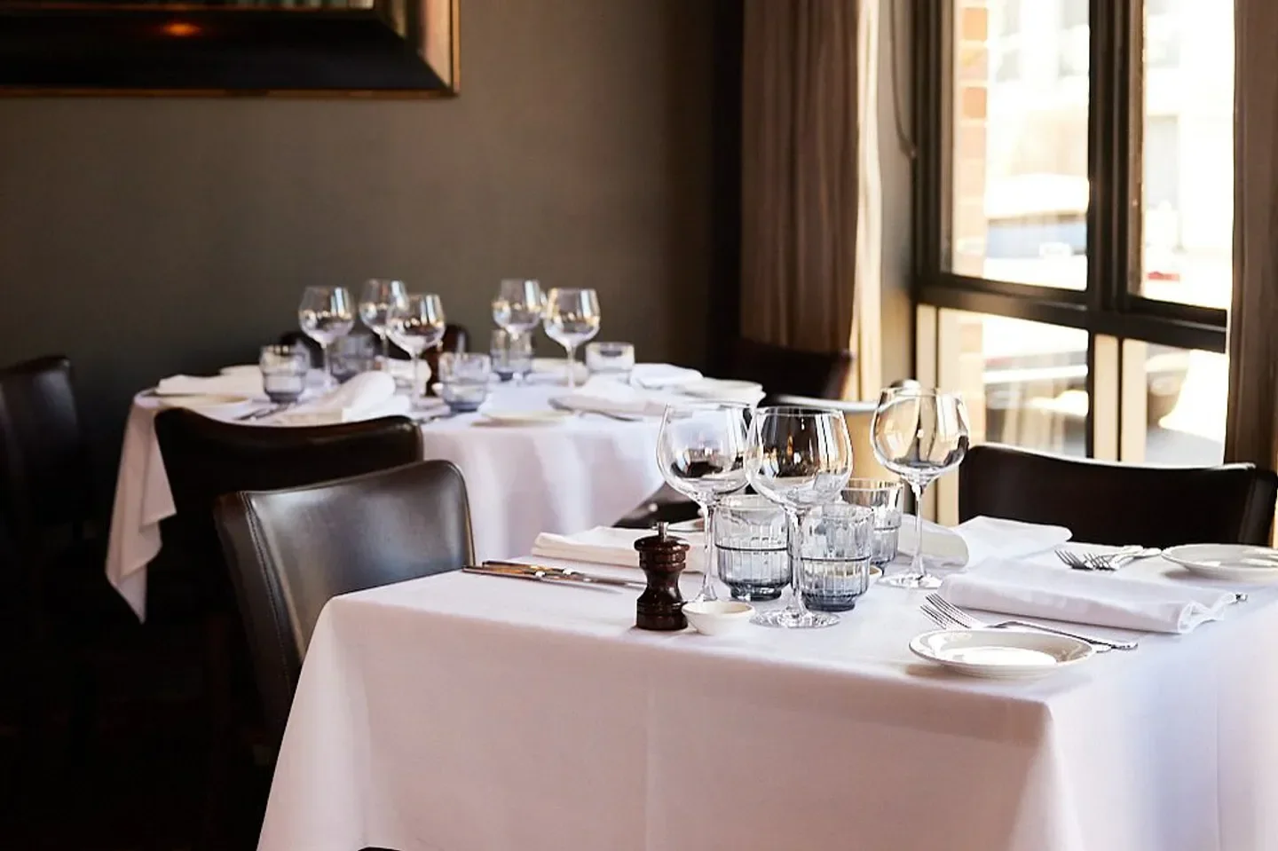 Elegant dining tables set for service inside Centonove restaurant in Melbourne.