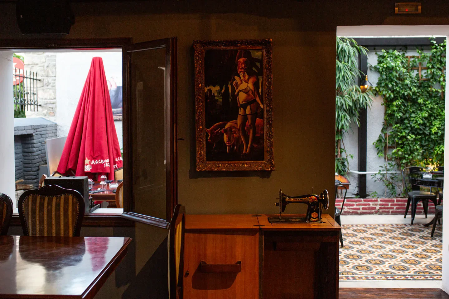 Interior view of Cerdo Negro restaurant in Athens, featuring a framed artwork and doorway.