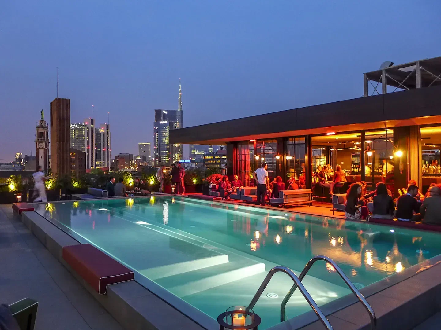 Rooftop pool at Ceresio 7 in Milan with city views at dusk