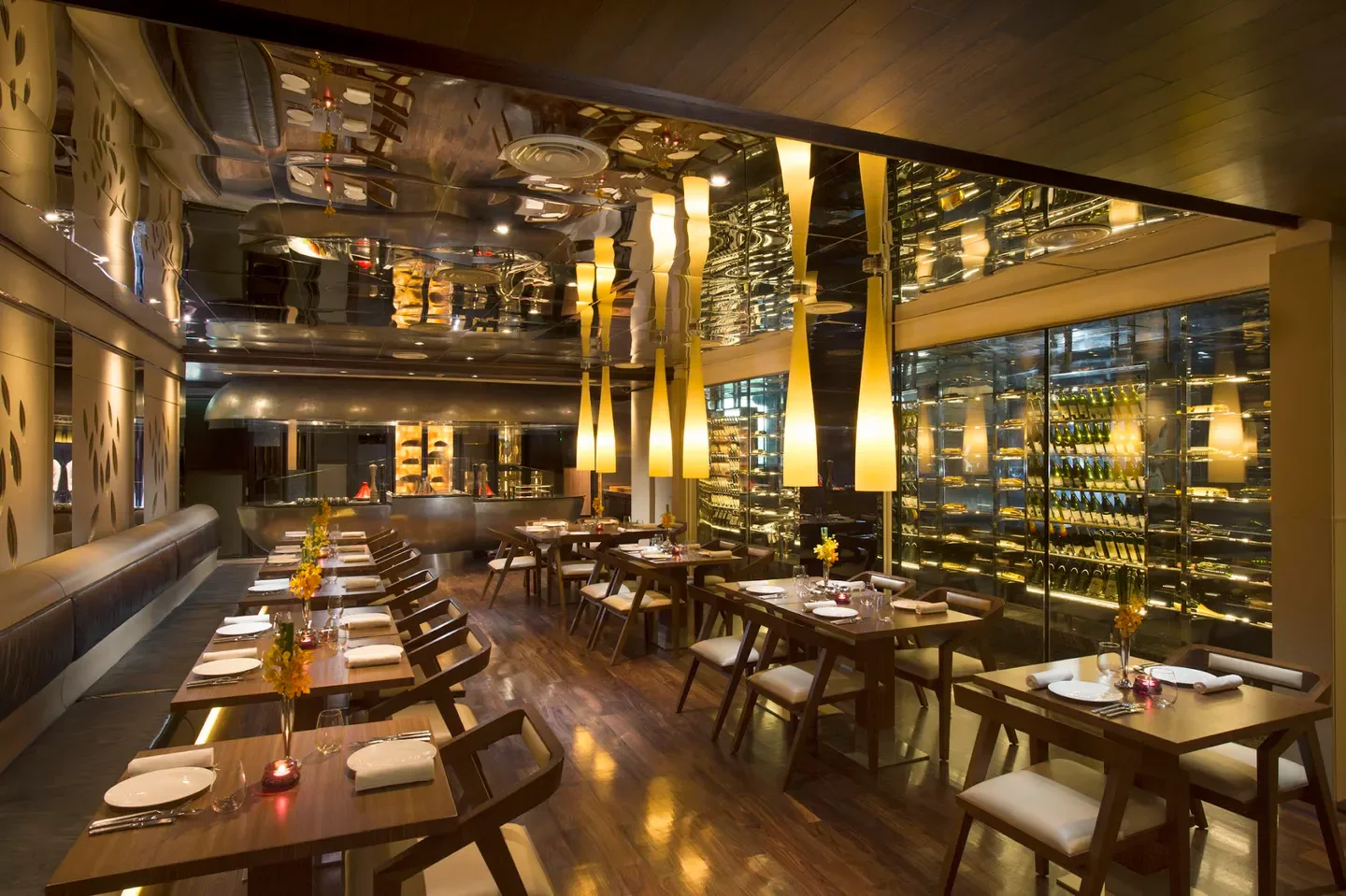 Interior dining at Chambers Grill in Kuala Lumpur, featuring tables and ambient lighting.