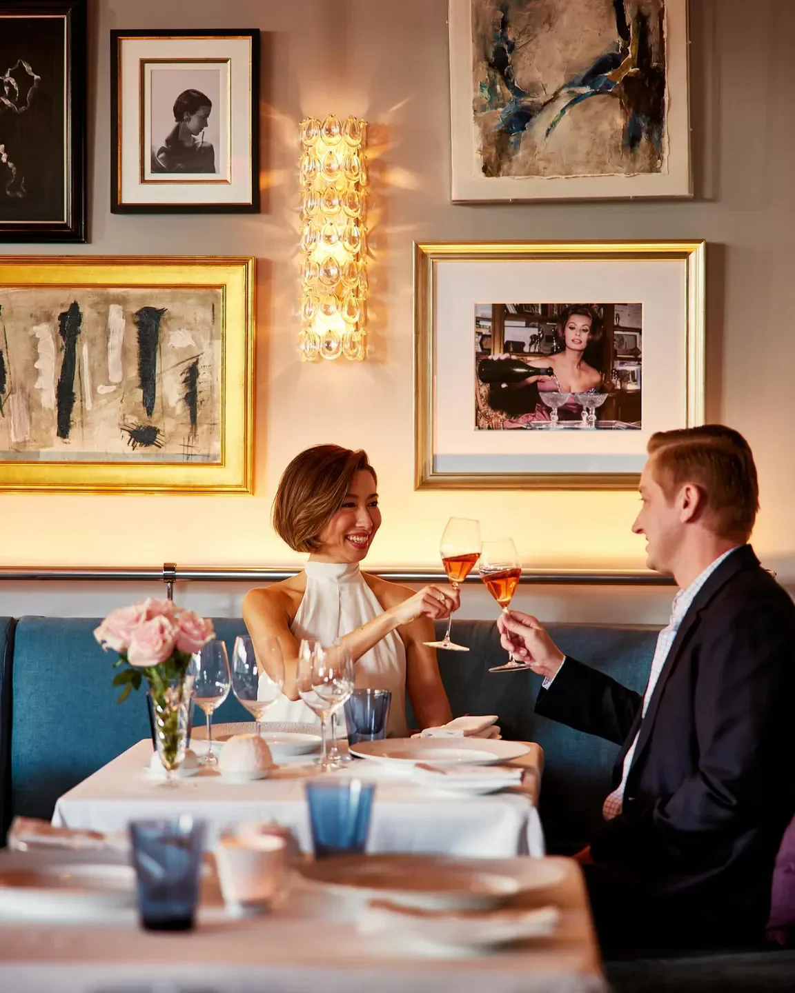 Couple toasting at Charleston in Baltimore restaurant, romantic fine dining experience.