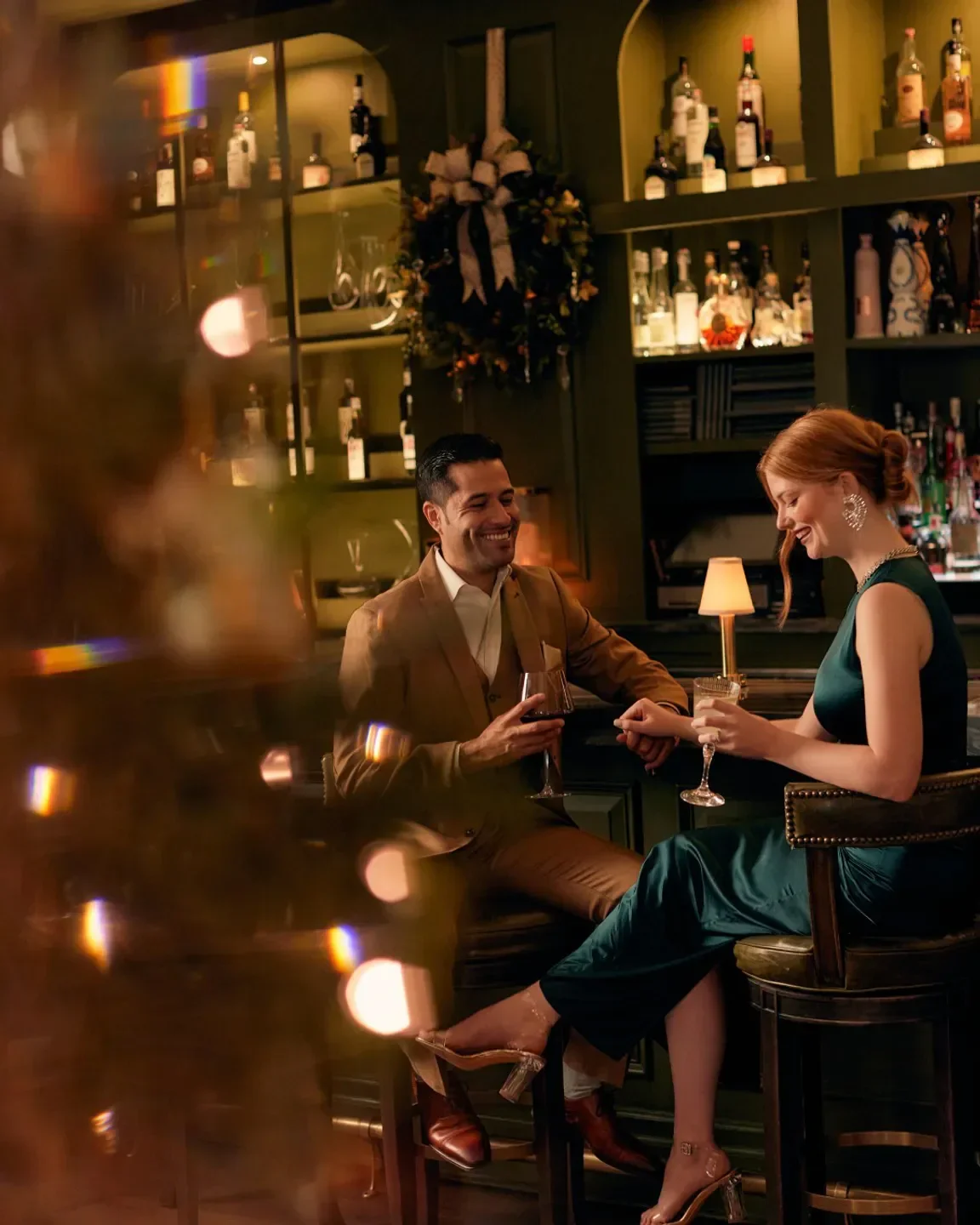 Couple enjoying drinks at the bar in Charleston Grill, a fine dining restaurant in Charleston.