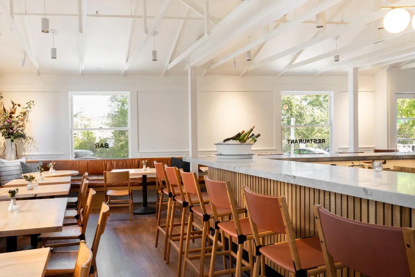Interior of Charlie's Napa Valley restaurant in Napa Valley, featuring bar seating and tables.