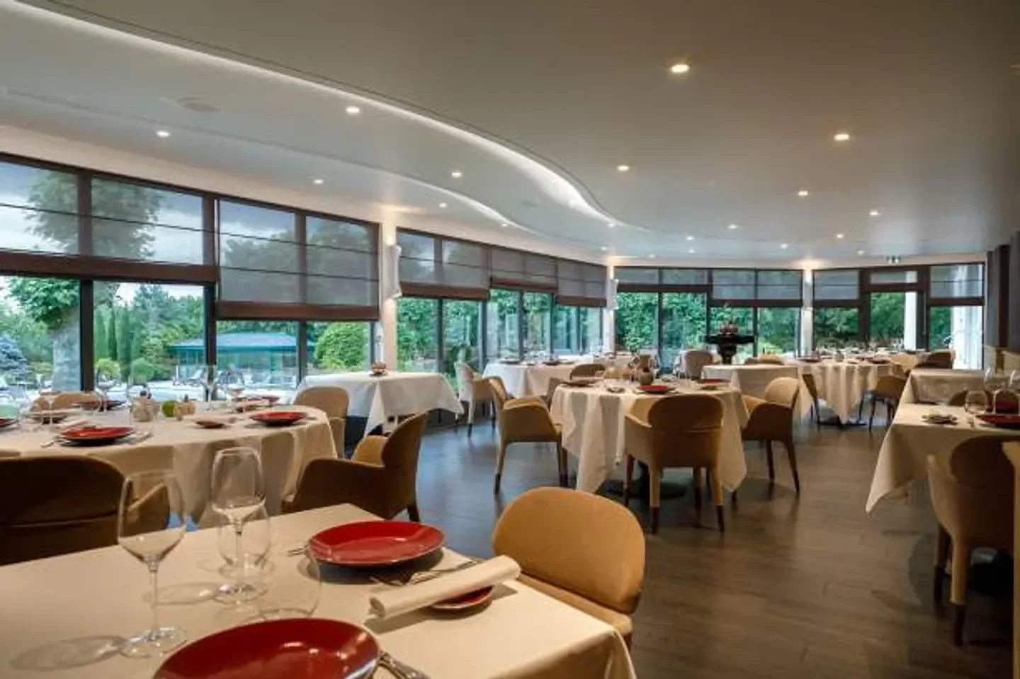 Elegant dining room at Château du Mont Joly in Bourgogne, with outdoor views and tables set