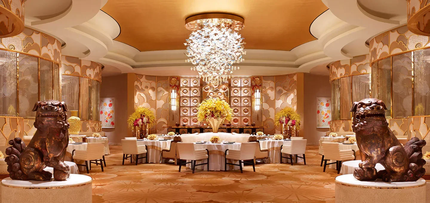 Elegant dining room at Chef Tam's Seasons restaurant in Macau, showcasing luxurious interior design.