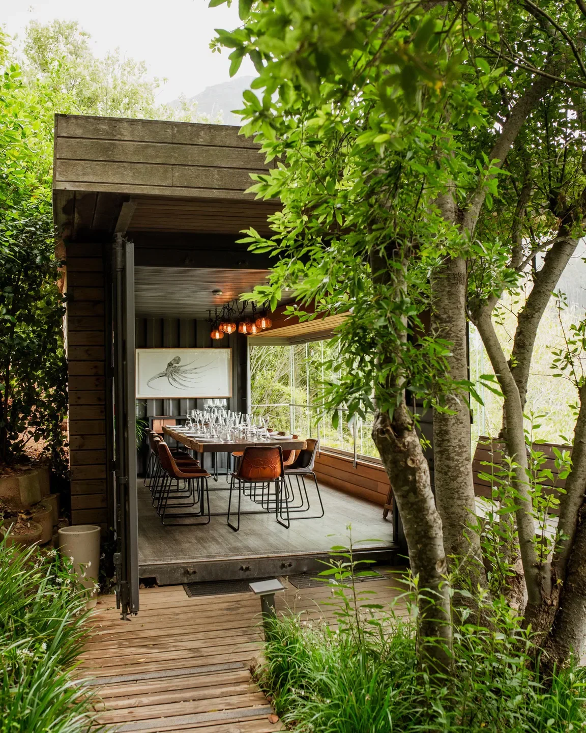 Outdoor dining area at Chef's Warehouse Beau Constantia in Cape Town, surrounded by lush greenery
