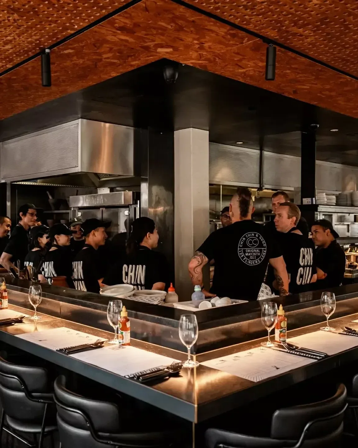 Inside Chin Chin Sydney restaurant: chefs and staff at the counter in Sydney.