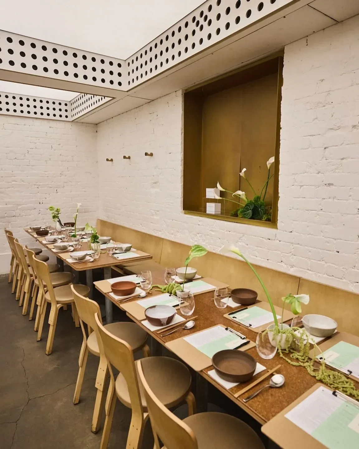 Interior dining space at Cho Cho San in Sydney, with long tables and modern decor.