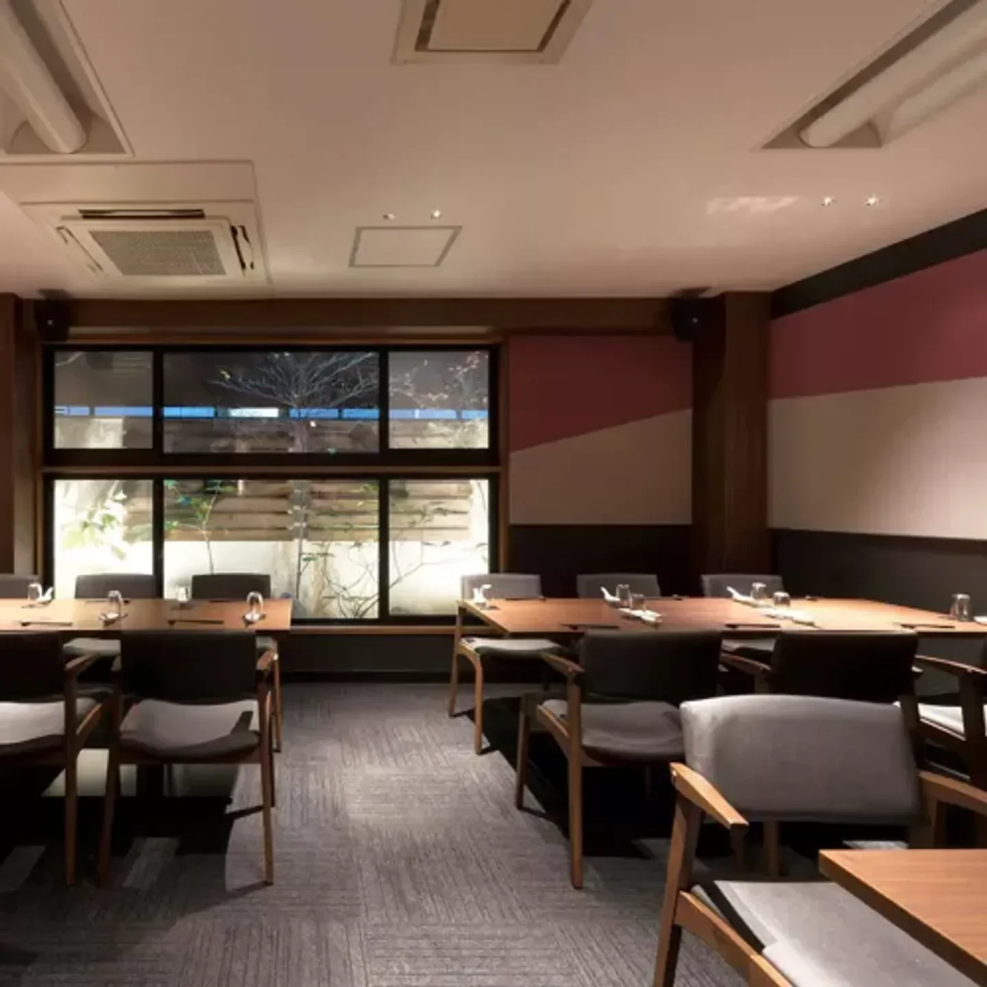 Elegant dining area at Chugokusai S.Sawada restaurant in Osaka with tables set for guests