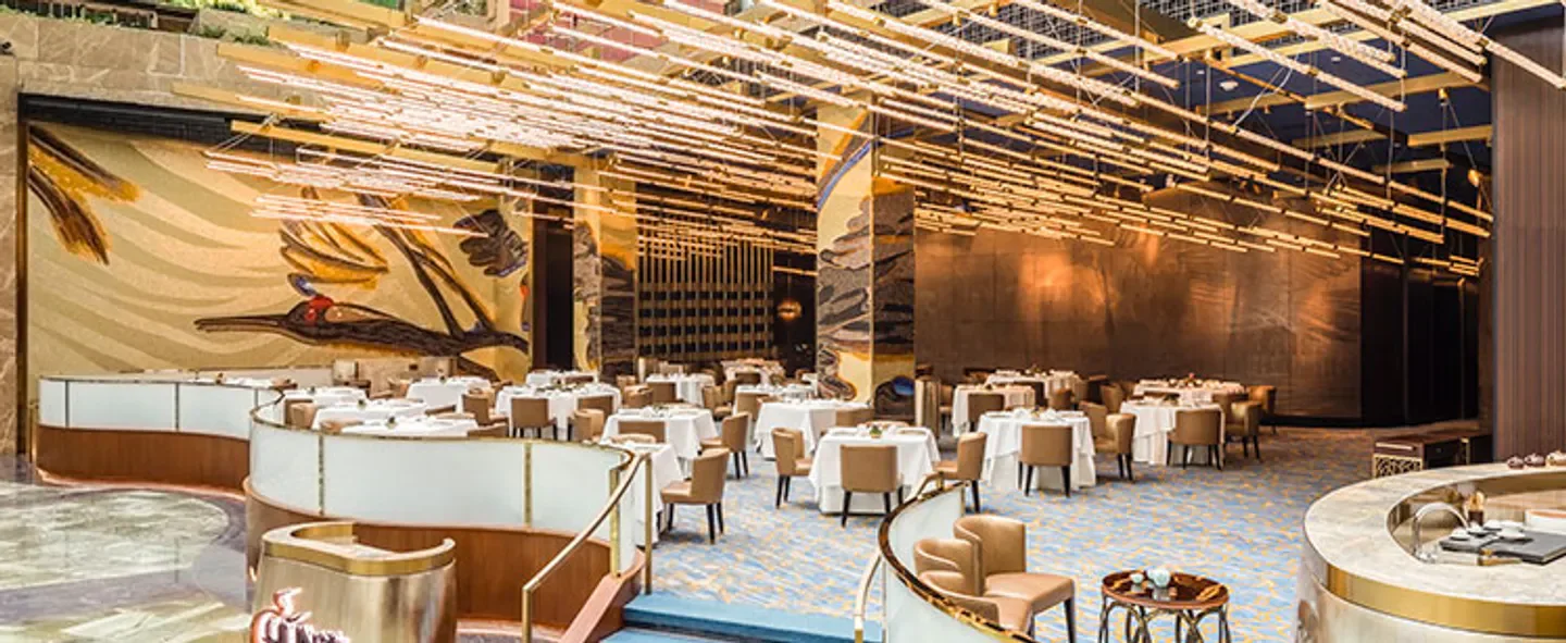 Elegant interior of Chún restaurant in Macau with unique lighting and mosaic artwork.
