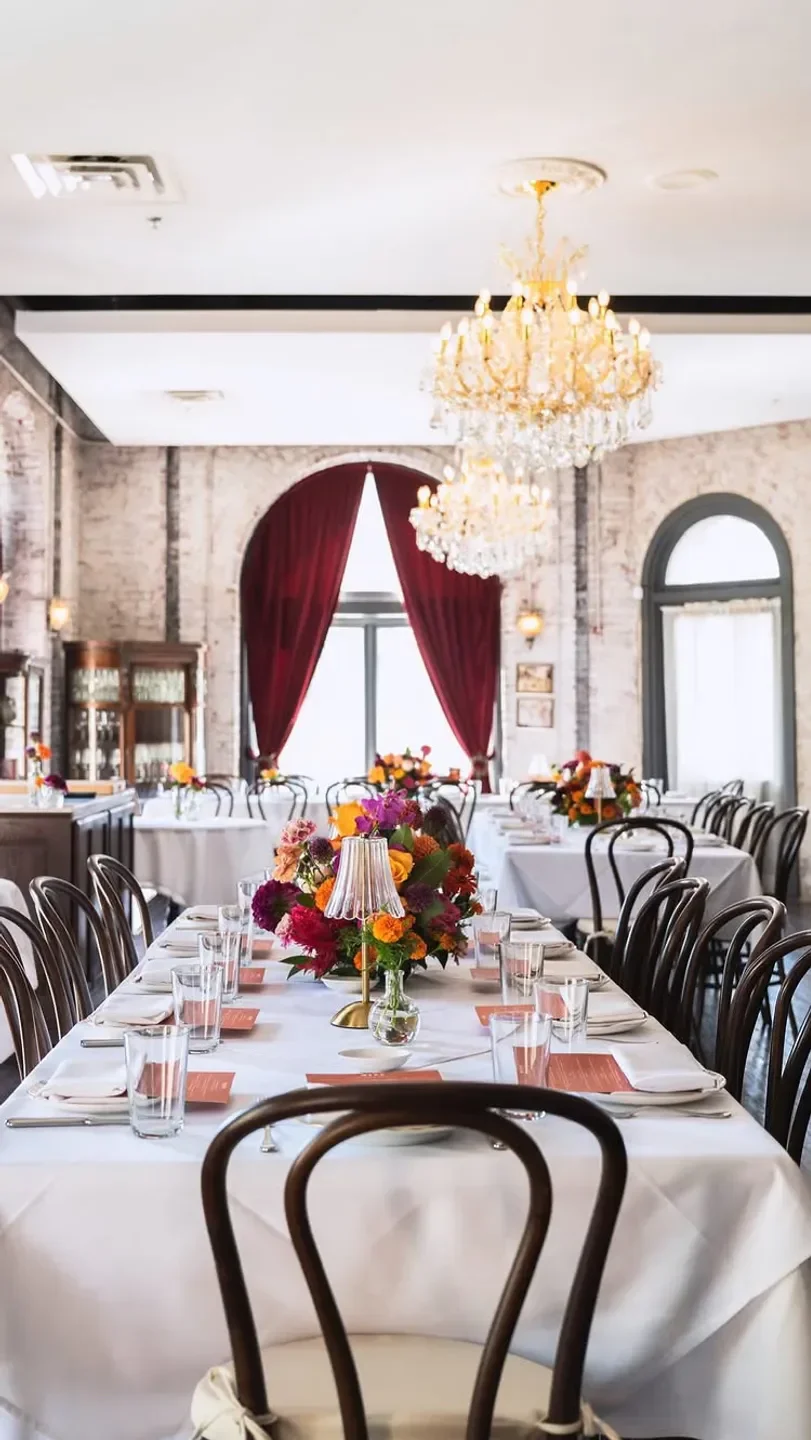 Elegant dining room at Cicala at the Divine Lorraine in Philadelphia with floral centerpieces.
