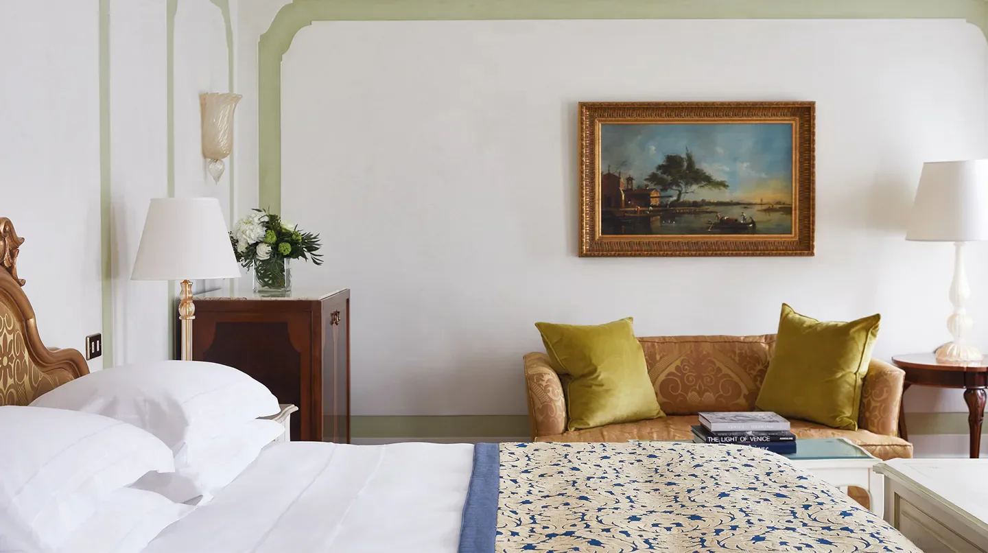 Elegant bedroom interior at Cipriani, A Belmond Hotel, Venice featuring classic art and decor
