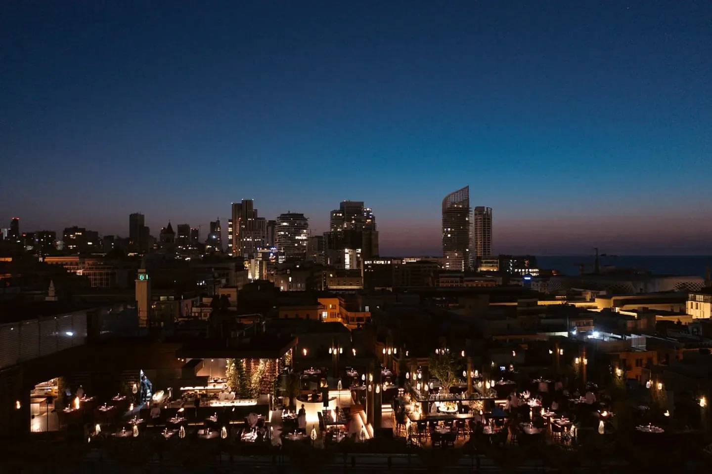 Night view of Clap Beirut restaurant in Beirut, Lebanon, with city lights and skyline