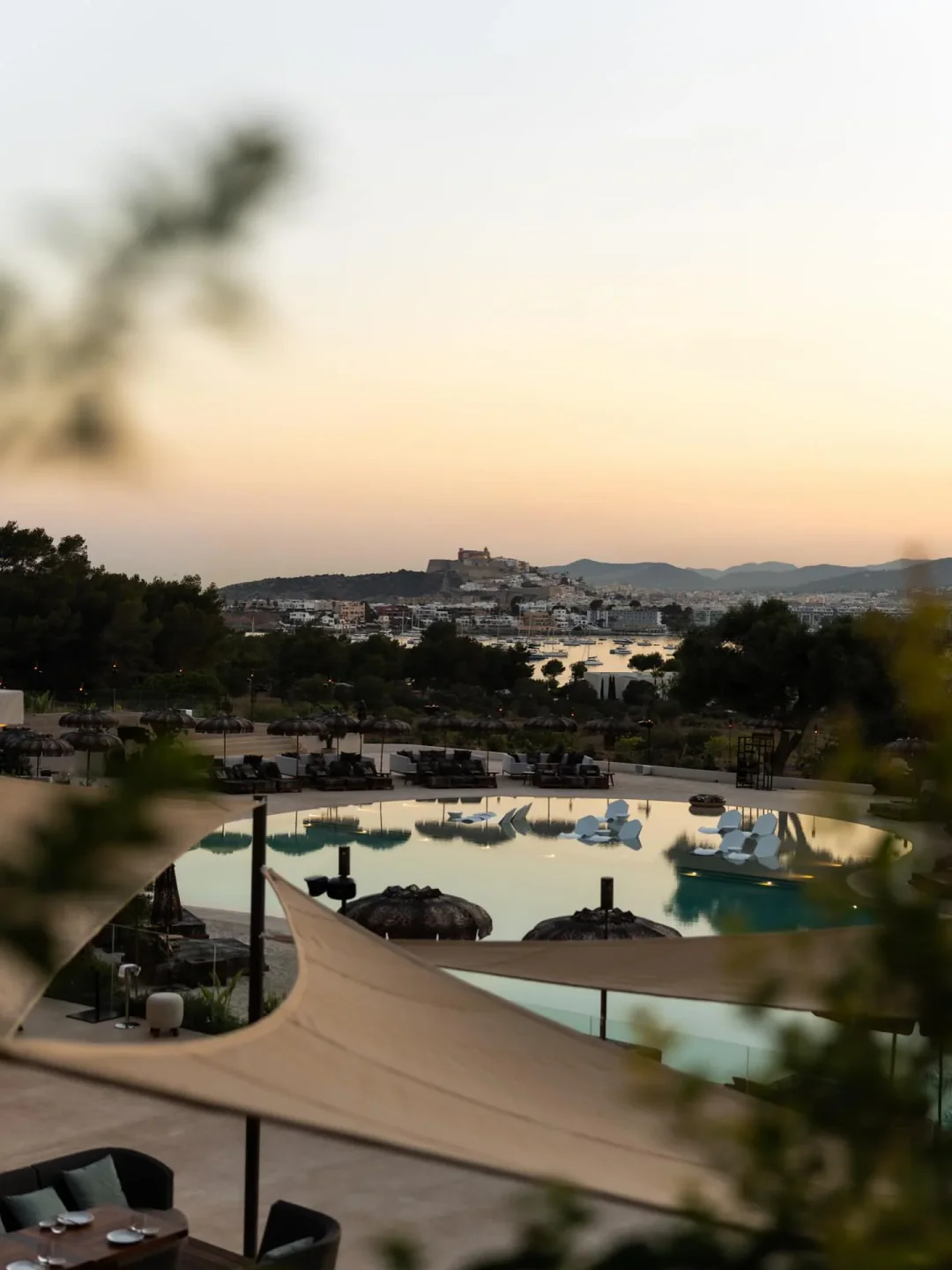 CLAP House beach club pool with Ibiza town view at sunset, luxury resort destination