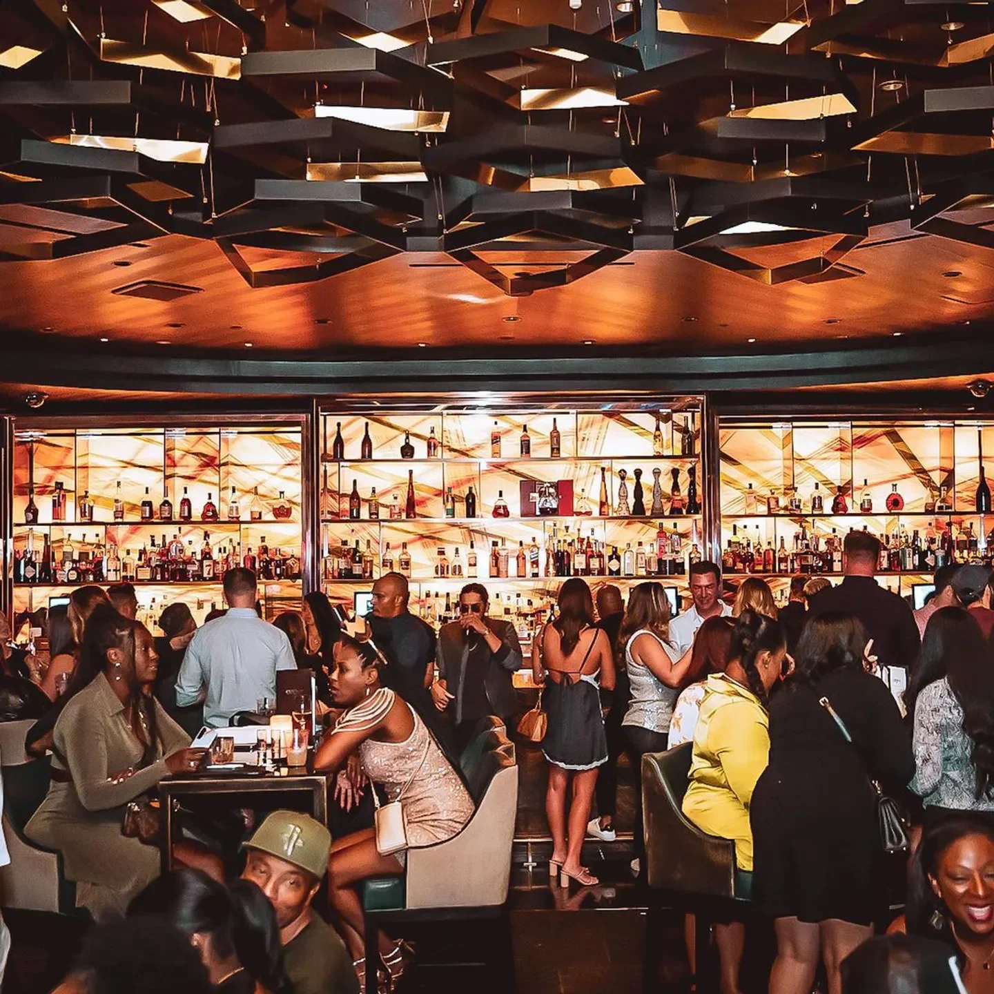 Busy nightlife at Clique Bar and Lounge in Las Vegas, with stylish interior and patrons.