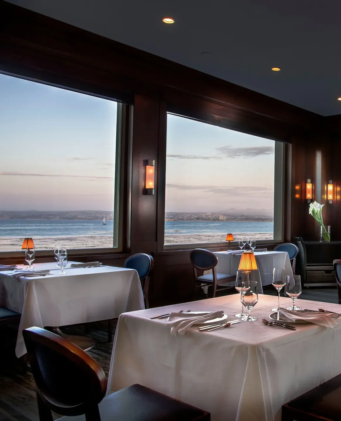 Coastal Kitchen in Monterey, California, overlooking the bay with elegant dining tables.