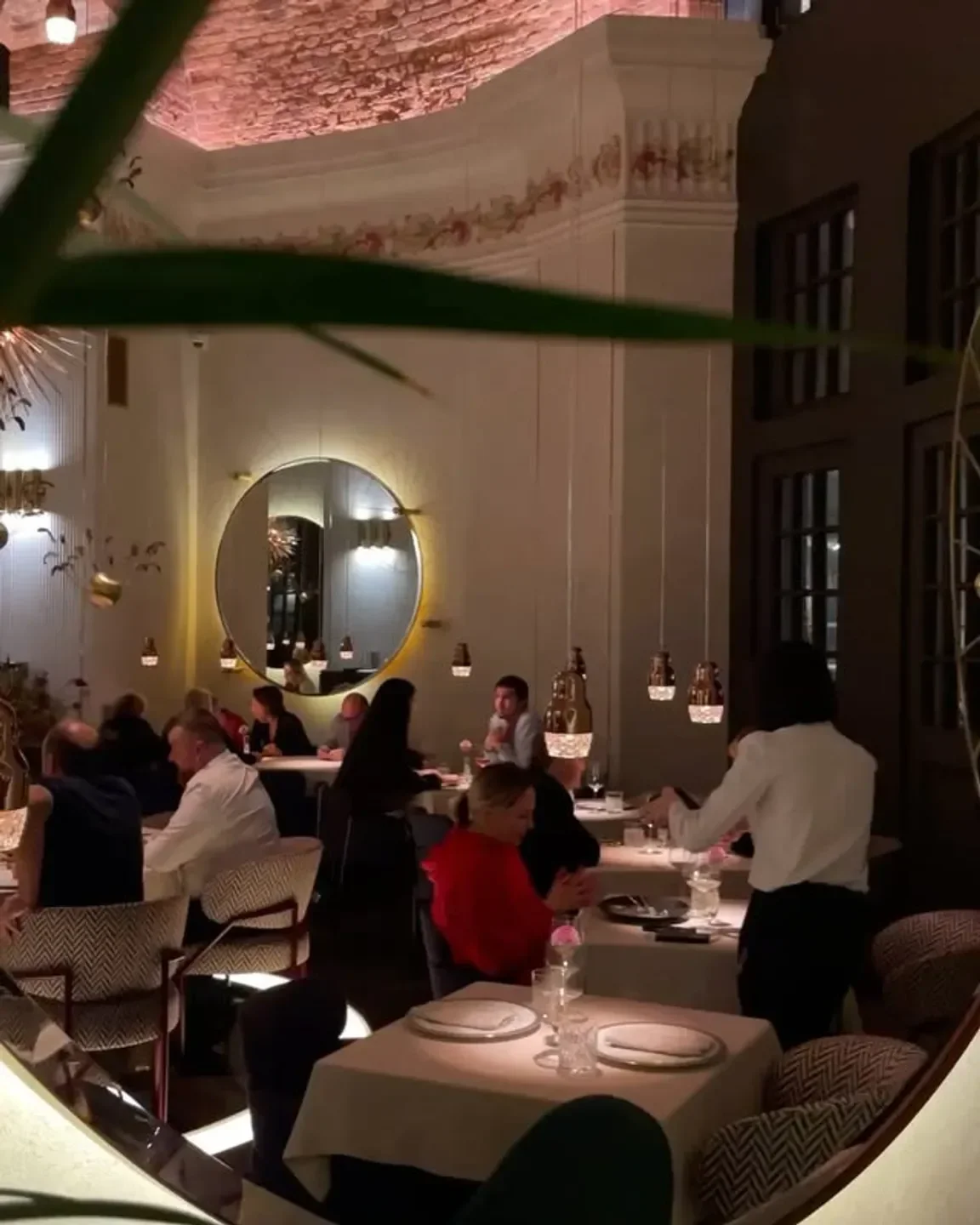 Elegant interior of CocoCouture restaurant in St Petersburg, featuring dining tables and decor.