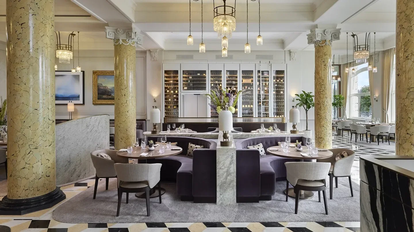Elegant interior of Colonnade restaurant in Lucerne, featuring marble columns and stylish seating