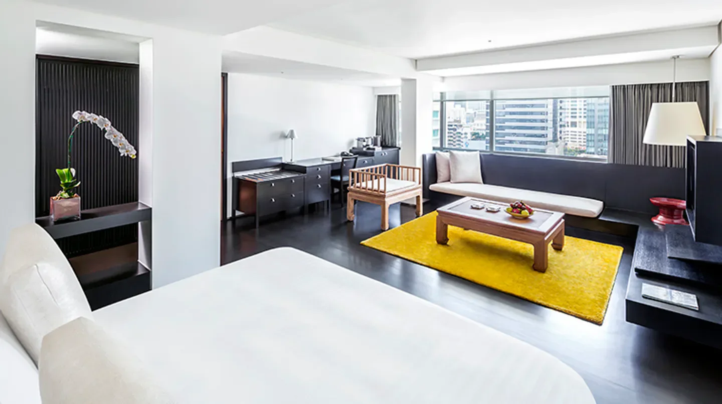 Stylish hotel room interior at COMO Metropolitan Bangkok, Bangkok, with city views and bright decor.