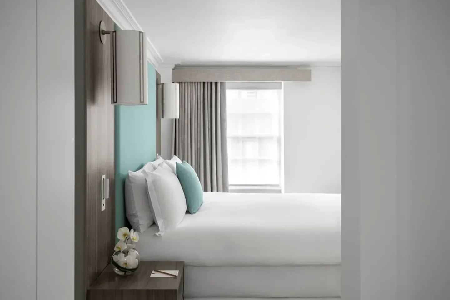 Stylish bedroom interior at COMO Metropolitan London hotel in London, featuring bright decor.