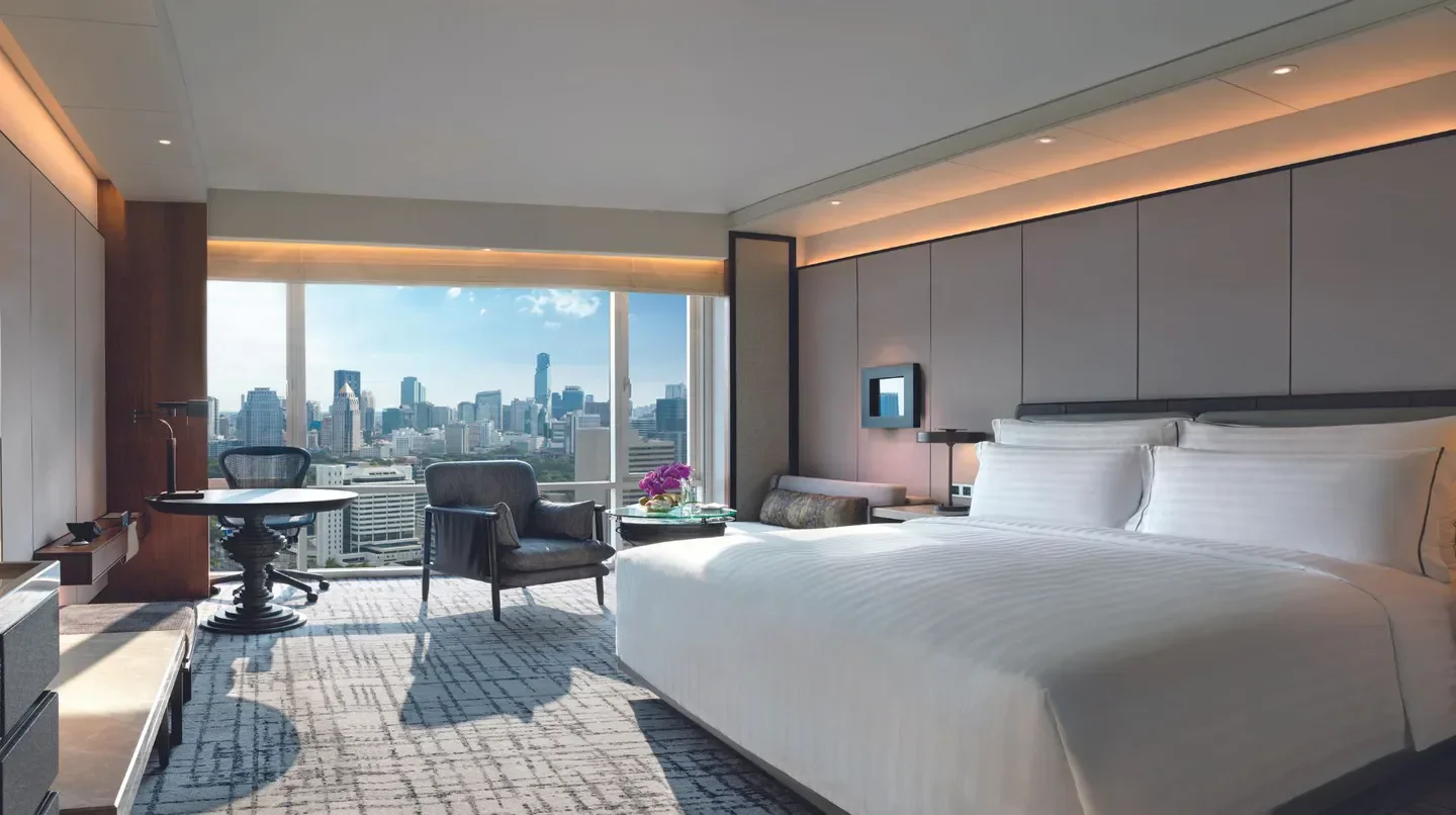 Luxury room with city views at Conrad Bangkok, overlooking Bangkok's skyline.