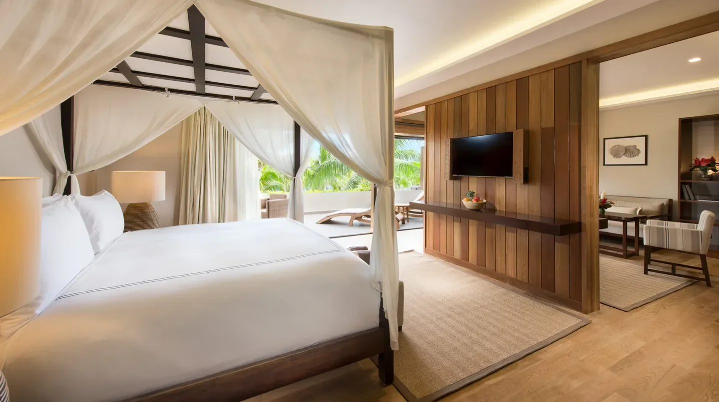 Elegant bedroom at Conrad Bora Bora Nui with a view of Bora Bora's tropical landscape.
