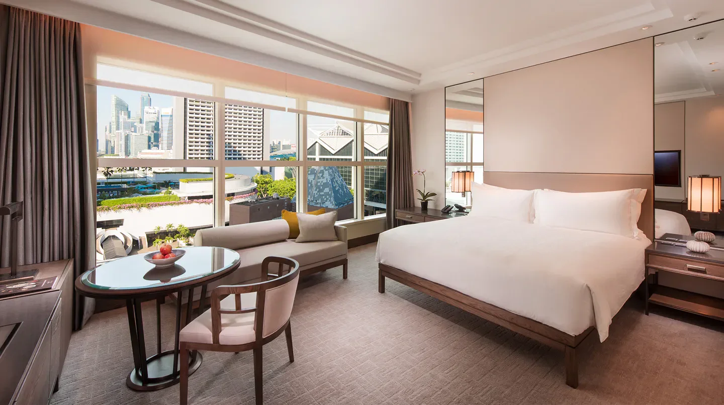 Elegant hotel room at Conrad Centennial Singapore, overlooking the Singapore skyline