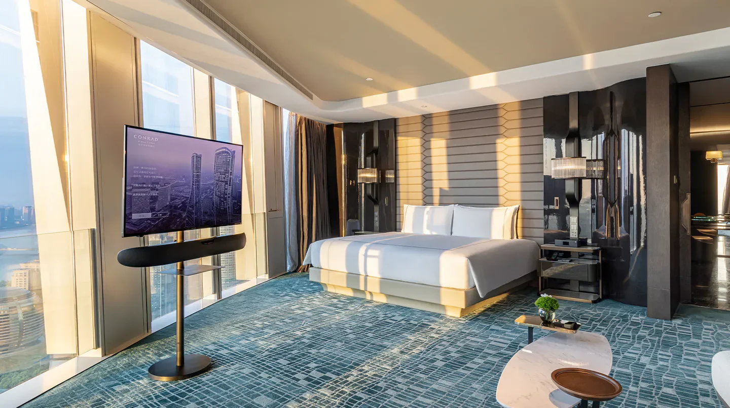 Luxury bedroom at Conrad Hangzhou hotel with city views in Hangzhou, China