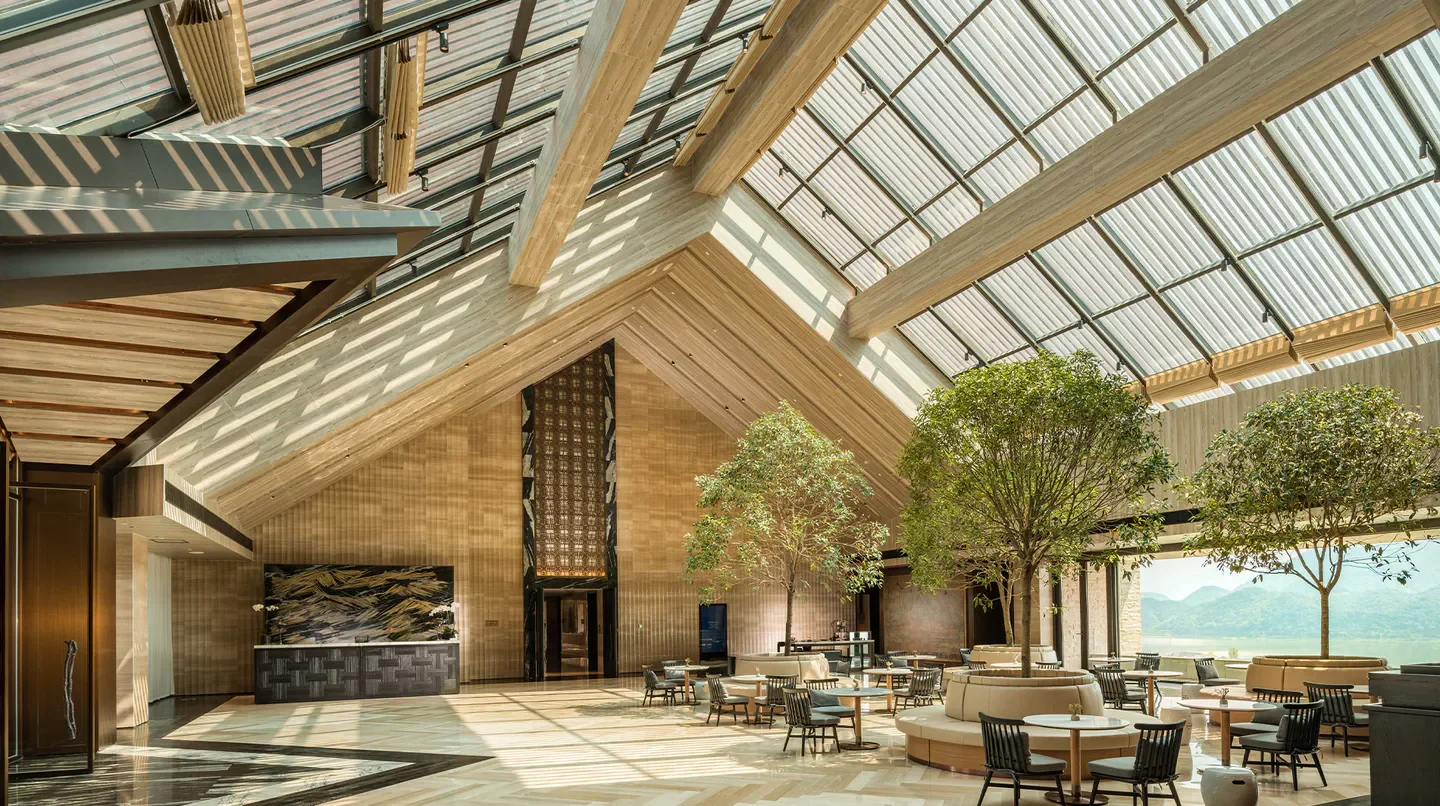 Conrad Hangzhou Tonglu hotel interior with trees, natural light, and views in Hangzhou.