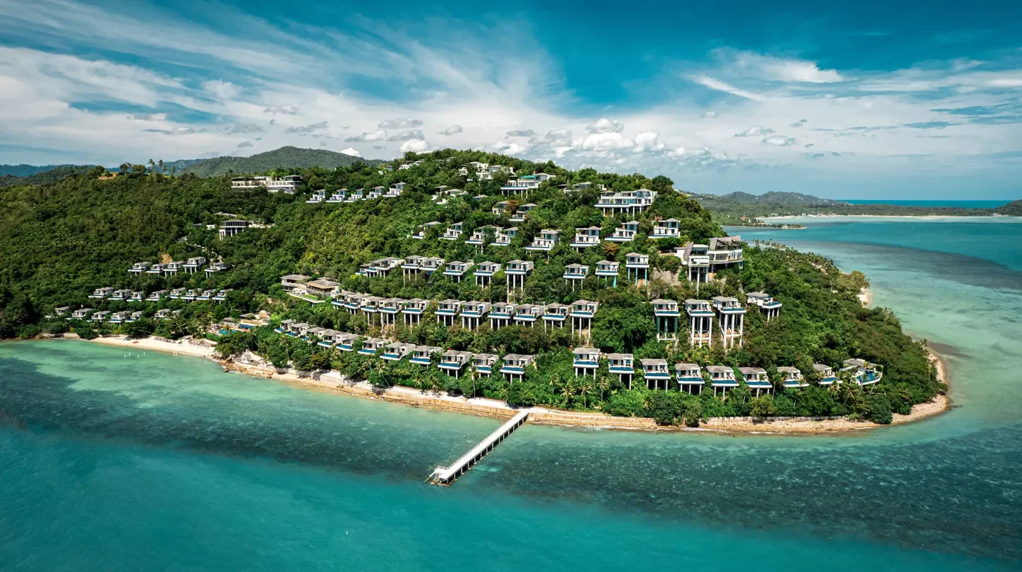 Aerial view of Conrad Koh Samui villas on a hillside overlooking the ocean in Koh Samui