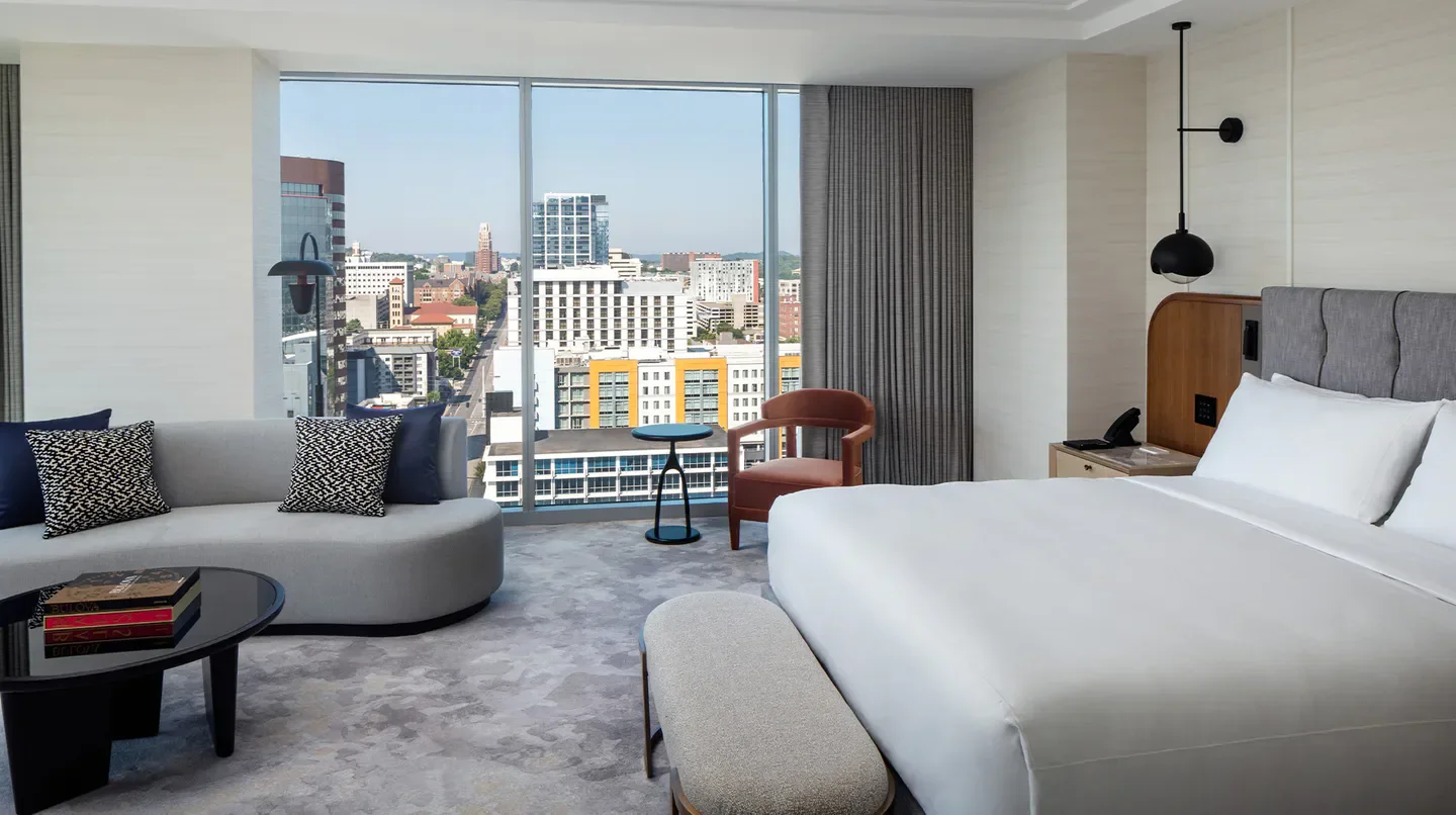Spacious hotel room with city views at Conrad Nashville, overlooking downtown Nashville.