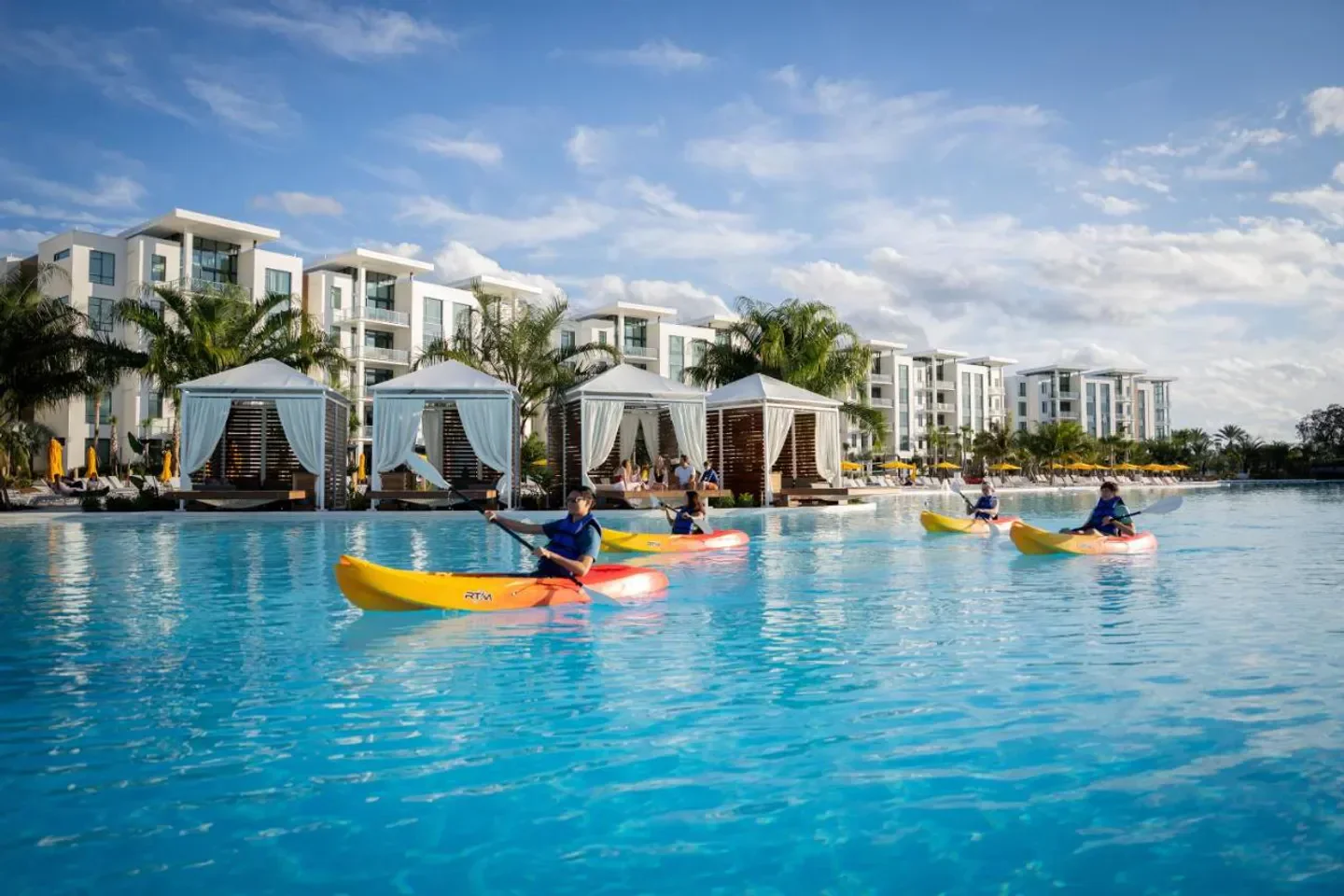 Kayaking at Conrad Orlando resort in Orlando with cabanas and modern architecture.
