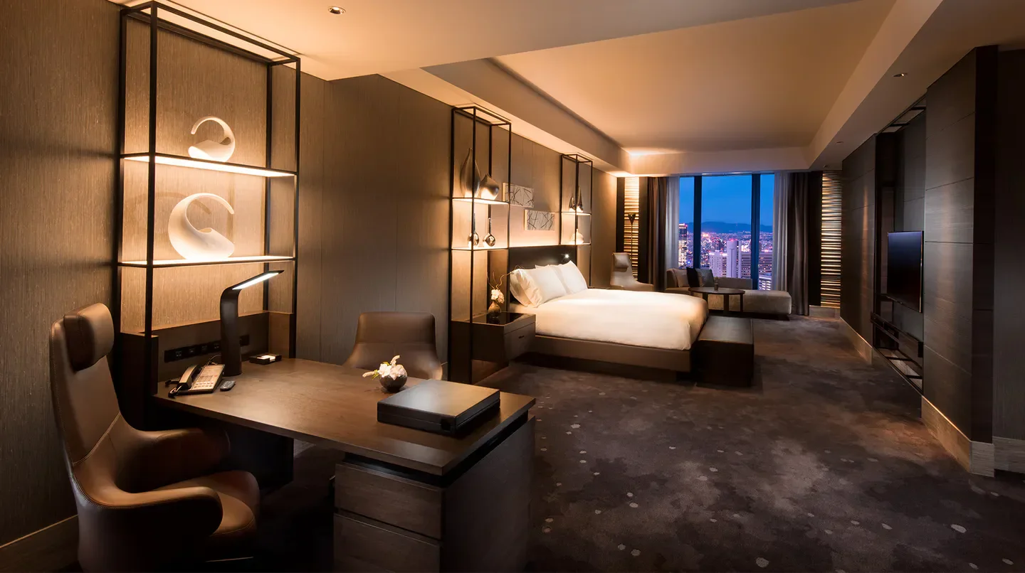 Luxury hotel room at Conrad Osaka with city views of Osaka at twilight