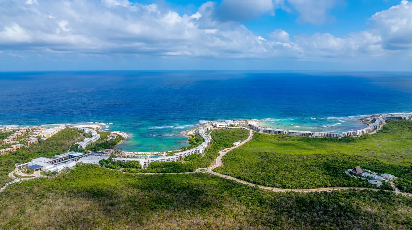 Aerial view of Conrad Tulum Riviera Maya hotel in Tulum, along the coastline.