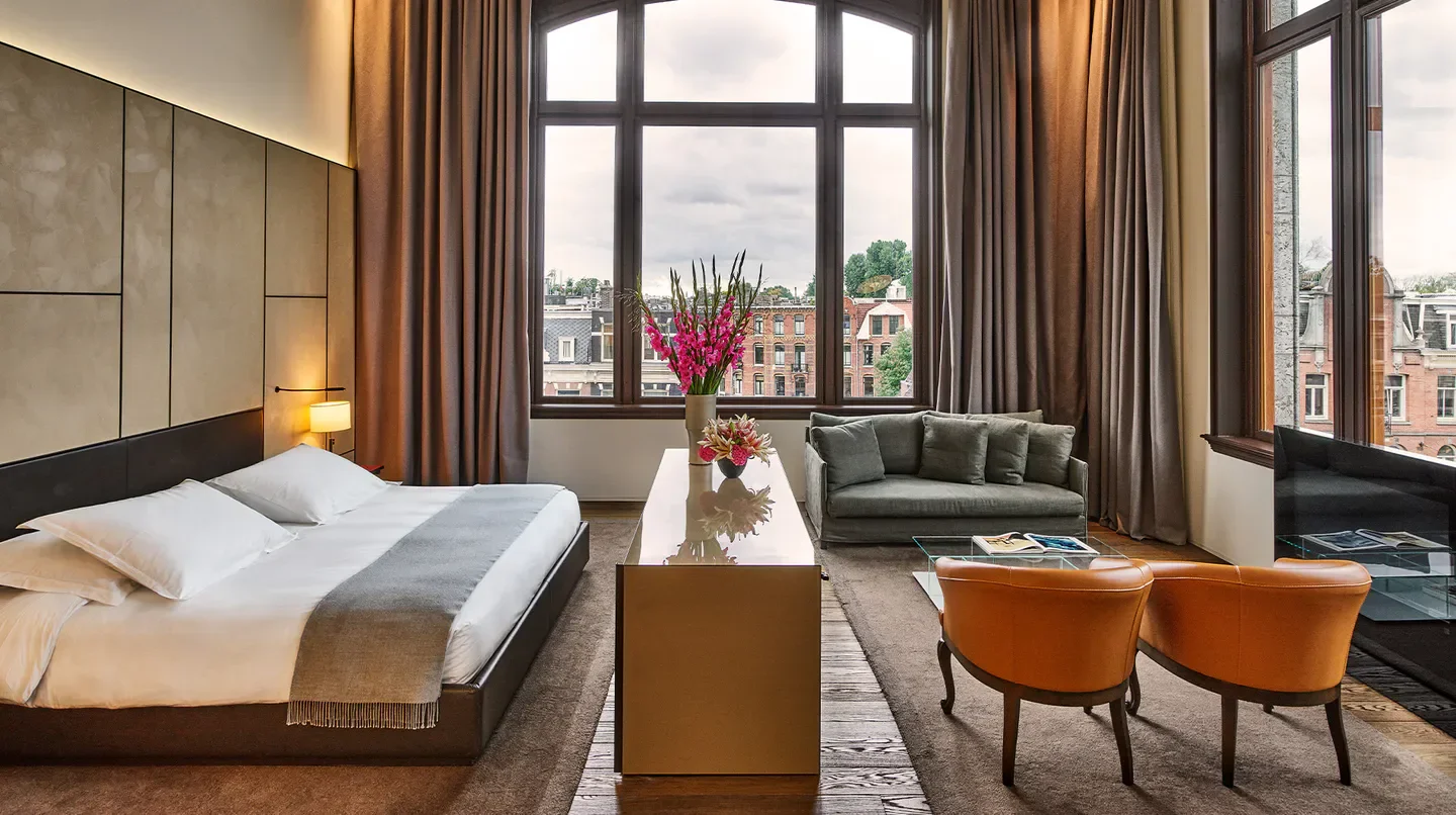 Luxury hotel room at Conservatorium Amsterdam with city view and stylish interior.