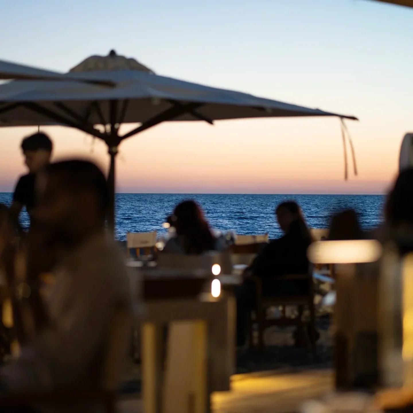 Controvento beach club ambiance at sunset overlooking the sea in the city
